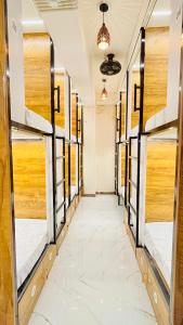 a row of bunk beds in a room with a hallway at LF Hotels in Kozhikode