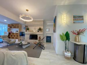 a living room with a couch and a fireplace at Versailles One Garden Villa Full Floor Suite in Koropi