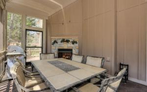 a dining room with a table and chairs and a fireplace at Choctaw Lodge -Play ping pong Relax by the wood fireplace Grill in Jasper