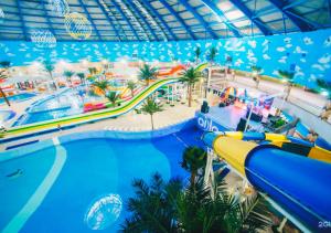 a water park at a resort with a water slide at Oasis апартаменты на левом берегу, новый ремонт in Astana