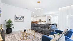 a living room with a couch and a table at Champions Gate 6BR Private Theater Games Pool Spa in Orlando