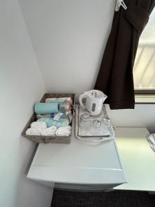 a white table with a tray of items on it at Sun flower Guest house in Tokyo +56 photos