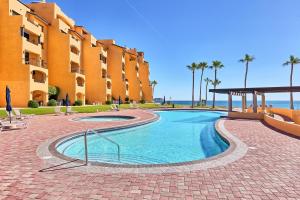 a swimming pool in front of a building at Princesa De Penasco in Punta Penasco New