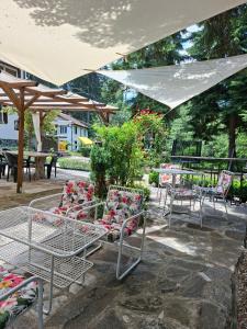 a group of chairs and tables under an umbrella at Villa Sveti Dimitar in Borovets