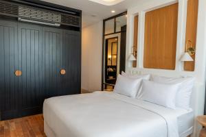 a bedroom with a large white bed with white pillows at Kiara Ocean Place in Canggu +47 photos