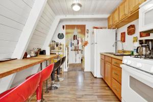 a kitchen with wooden counter tops and red chairs at Sunrise cottage #1800 in Big Bear City +11 photos