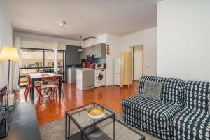 a living room with a couch and a table at Rocha Beach Apartment in Praia da Rocha
