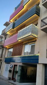 a building with balconies on the side of it at Murella Living in Marsalforn