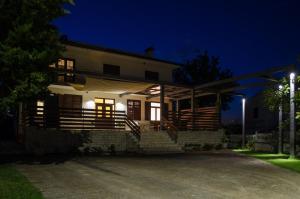 a white house with a porch at night at Luxury Istrian Apartment ZP in Marčana