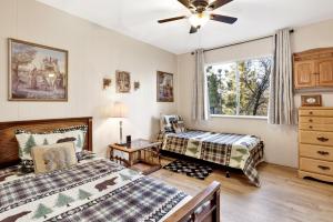 a bedroom with two beds and a ceiling fan at A hidden asset #2379 in Big Bear Lake +11 photos