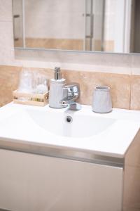 a bathroom counter with a sink and a mirror at Il Nido del Falco Apartment in Castel Gandolfo +14 photos
