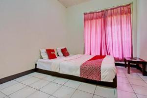 Ένα ή περισσότερα κρεβάτια σε δωμάτιο στο Hotel O Fj Guest House