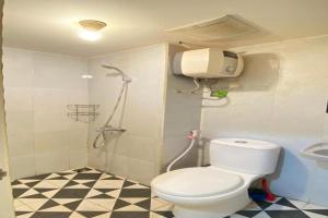 a bathroom with a shower and a toilet and a sink at OYO 94024 Sentraland karawang By Aswin in Poponcal 2 +77 photos