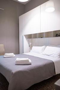 a bedroom with a large bed with two towels on it at Il Nido del Falco Apartment in Castel Gandolfo
