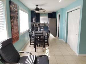 a dining room with blue walls and a table and chairs at 206 on 10th St - All in Saint Augustine
