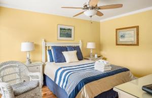 a bedroom with a bed and a ceiling fan at 115 Capt John Fripp Villa in Fripp Island +39 photos