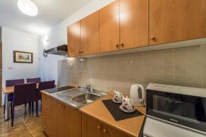 a kitchen with a sink and a counter top at Apartment Divald in Osijek