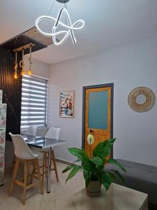 a dining room and living room with a table and chairs at Helios Hotel&Hostel in Shkodër