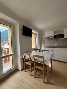 a dining room with a table and chairs and a window at Tre Cime Apartments - monolocali in Auronzo di Cadore