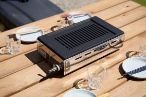 a toaster sitting on a table with plates and glasses at WATERSIDE Base 鹿嶋 北浦 in Kashima