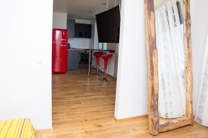 a mirror in a living room with a red refrigerator at Uus Street 34 Apartment in Kuressaare