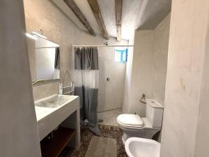 a bathroom with a toilet and a sink and a shower at Casa Chiara, terrace with sea view in Malfa