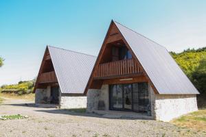 a house with a metal roof on a hill at Peradze Wine Cellar Vineyard Cottages in Khidistʼavi