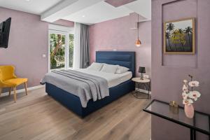 a bedroom with a bed and a table and a chair at Luxurious VILLA LAPIS - heated pool, sauna, gym and spa, 120m to sandy beach in Omiš +49 photos