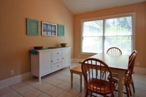 a kitchen with a table and chairs and a window at 423 Wahoo Dr in Fripp Island