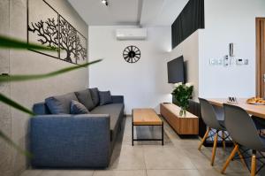 a living room with a blue couch and a table at Revel Apart in Zator