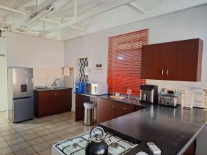 a kitchen with a counter top and a stove in it at Country Route LTX in Lichtenburg