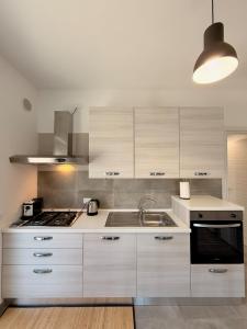 a kitchen with a sink and a stove at Dimora Bella Vista in LʼAquila +1 photo