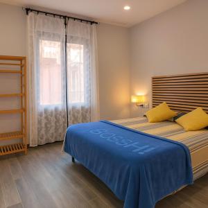 a bedroom with two beds and a window at Apartamentos Turísticos Tenor by Bossh! Hotels in Barcelona