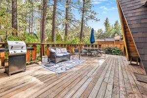 a deck with a grill and a table and chairs at Sugar Bear Pines #2493 in Sugarloaf