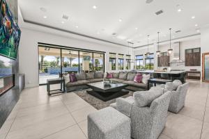 a living room with a couch and a table at Palm Villa- Luxury 7 Bed, Pickleball, Volleyball, Golf in Indio
