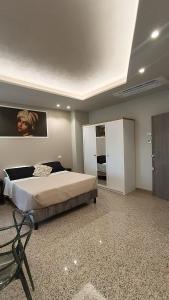 a bedroom with a large bed and a mirror at Le Manzé in Torremaggiore