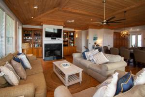 a living room with couches and a tv and a fireplace at 449 Tarpon Blvd in Fripp Island