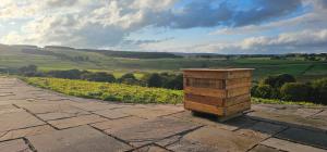 a wooden box sitting on top of a stone walkway at Auchenhill Lodge in Denny