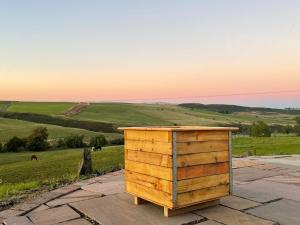 a wooden box sitting on top of a field at Auchenhill Lodge in Denny