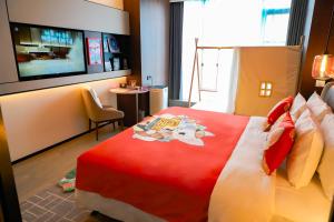 a hotel room with a bed and a tv at Wanda Jin Xiaohe Xincheng in Taiyuan