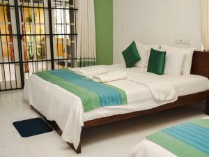 Letto o letti in una camera di The Panorama Negombo