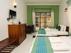 Letto o letti in una camera di The Panorama Negombo