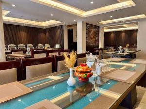 a dining room with a long table and chairs at The Nalanda Boho in Leh