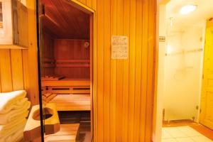 a small room with a bed in a wooden room at Hotel Roses in Strasbourg