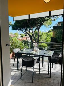 a black table and chairs on a patio at Damiano Chiesa terrazzato -Flexrent Immobiliare Abissinia in Riccione