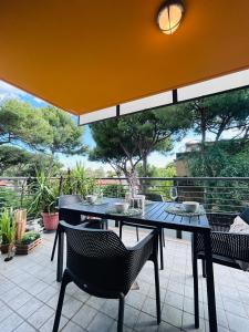 a table and chairs sitting on a patio at Damiano Chiesa terrazzato -Flexrent Immobiliare Abissinia in Riccione +23 photos