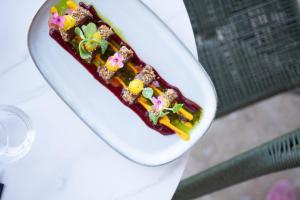 a white plate of food on a table at Hôtel - Restaurant U Santu Petru in Saint-Florent