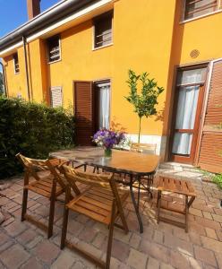 a wooden table and chairs on a patio at La Casa di Athope in Castel di Sangro +8 photos
