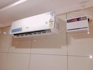 a microwave oven sitting on top of a white wall at GM Residency Beach Inn in Velankanni