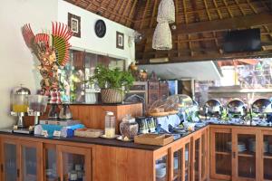 a kitchen with wooden cabinets and a counter top at Puri Dewa Bharata Hotel & Villas in Legian